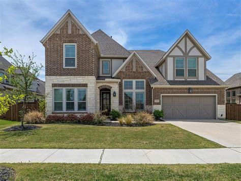 The pronounced front entry opens to a two-story foyer with a grand curved staircase. . Zillow prosper tx
